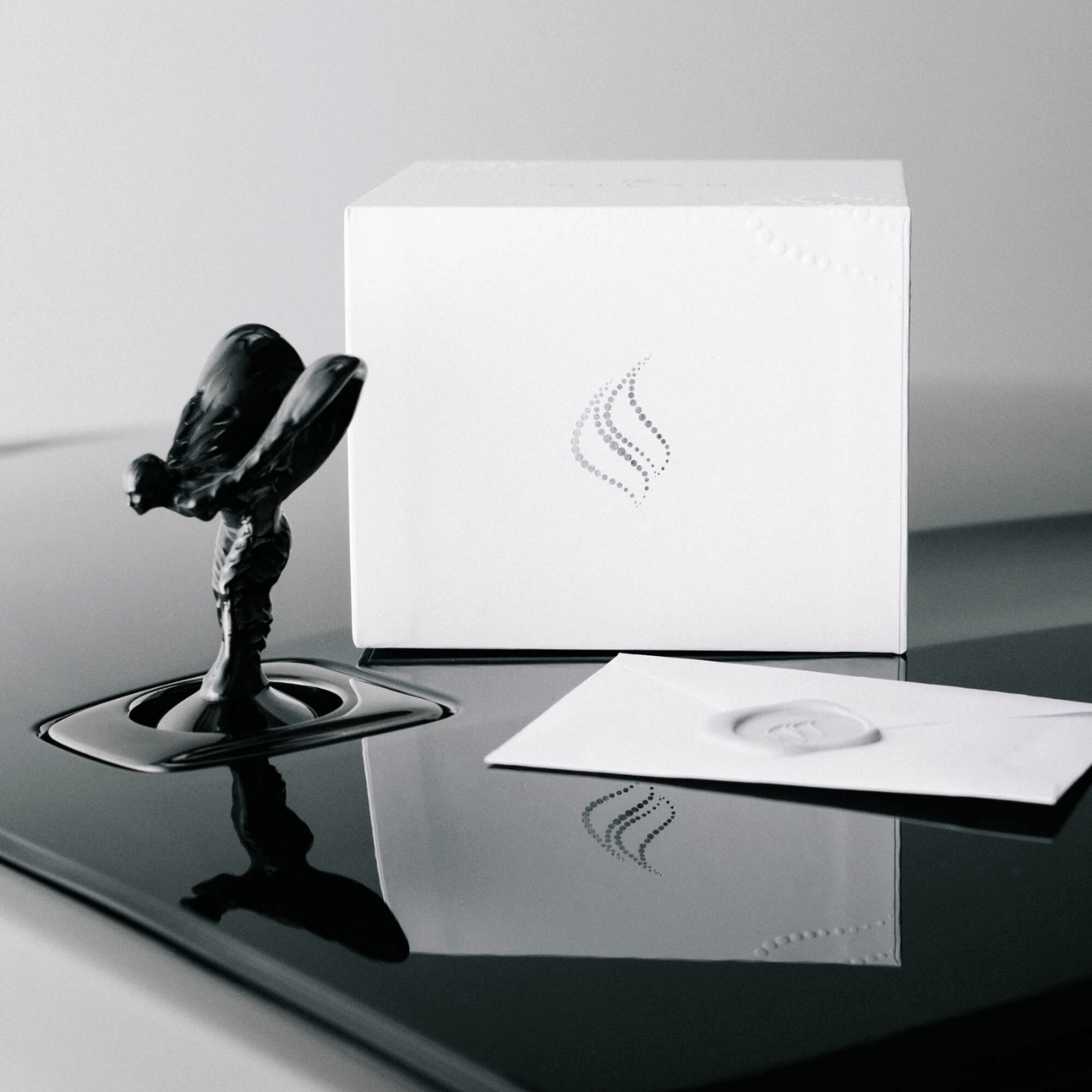 Milan Candles Box on the hood of a Black Badge Ghost by Rolls Royce to showcase the exclusive collaboration