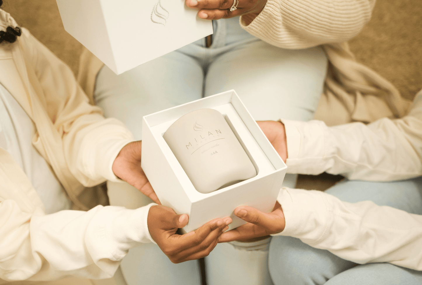 Women and girls exchanging a Milan Candle Gift