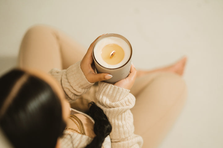 Woman meditating with a Milan Candle