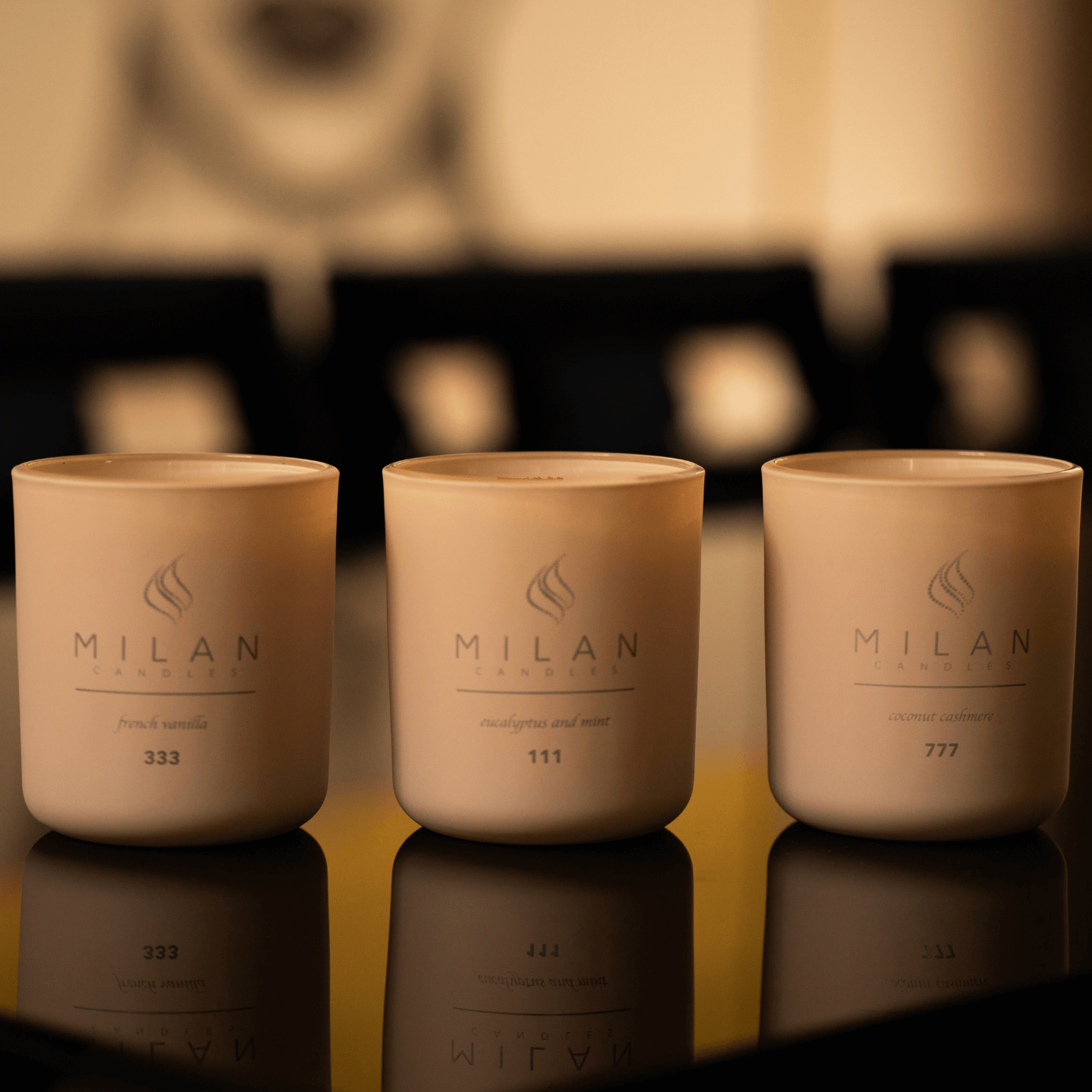 Three Milan candles with the numbers 111, 333, 777 on a piano