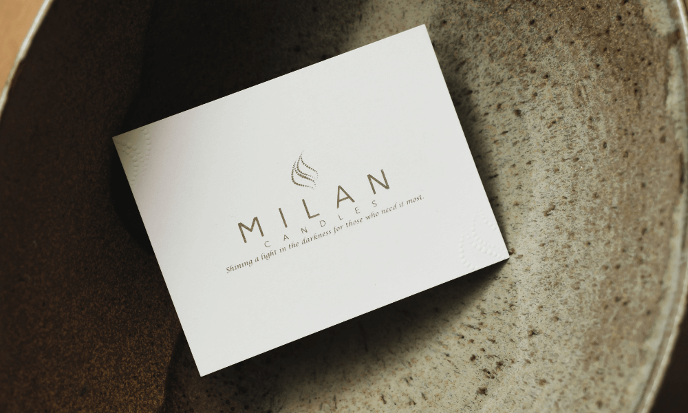 White card with 'Milan' branding on a textured surface